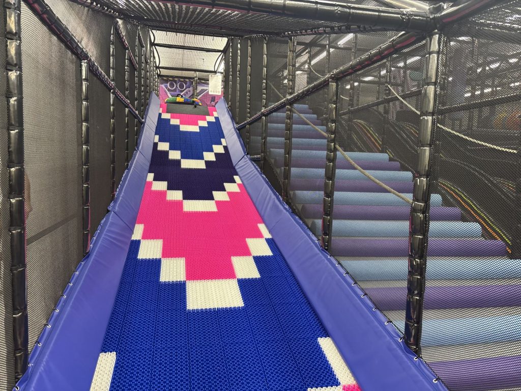 Wide patterned slide viewed from the top of the play structure