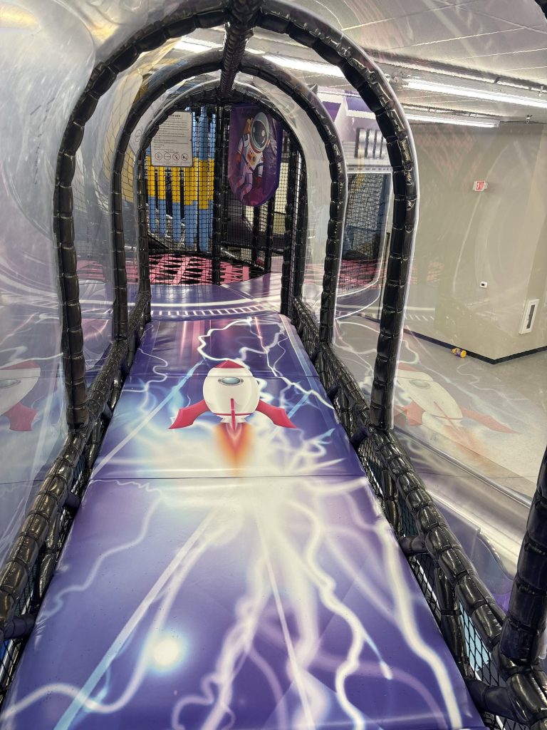 Enclosed tunnel slide with rocket and lightning graphics