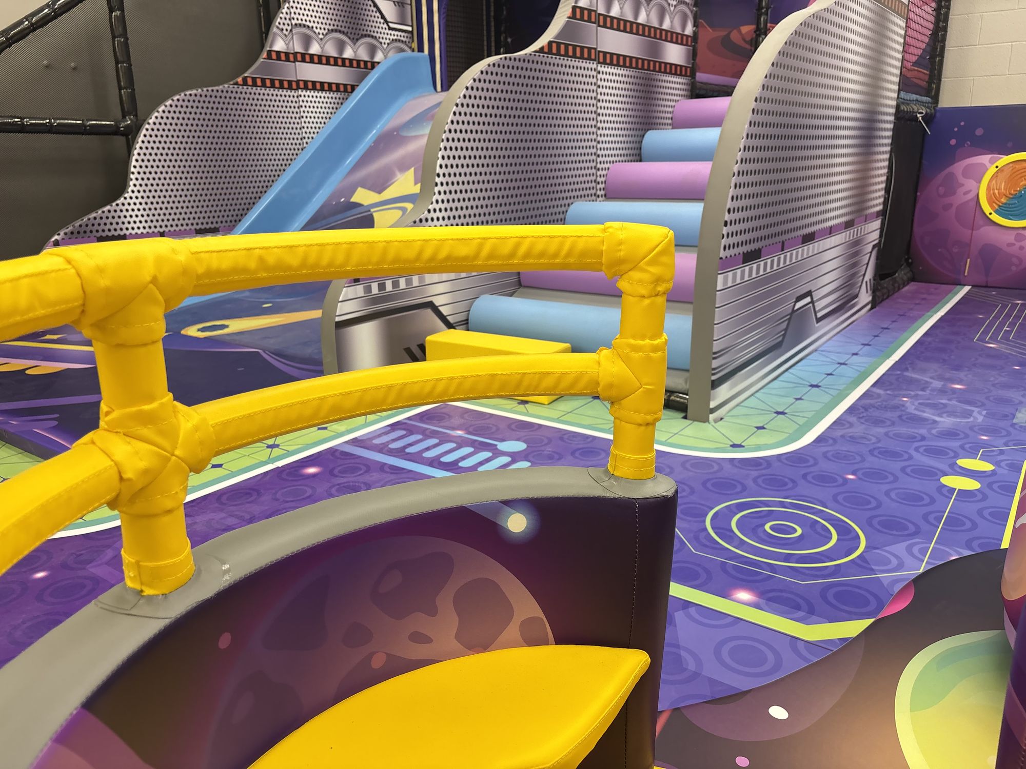 Low slides and soft rails in the toddler area, sized for ages 0 to 3